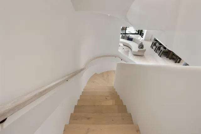 a white bath tub sitting in a bathroom next to a window