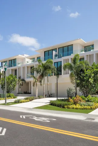 a white house with a yard and plants