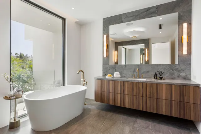 a bathroom with a granite countertop sink a toilet and a mirror