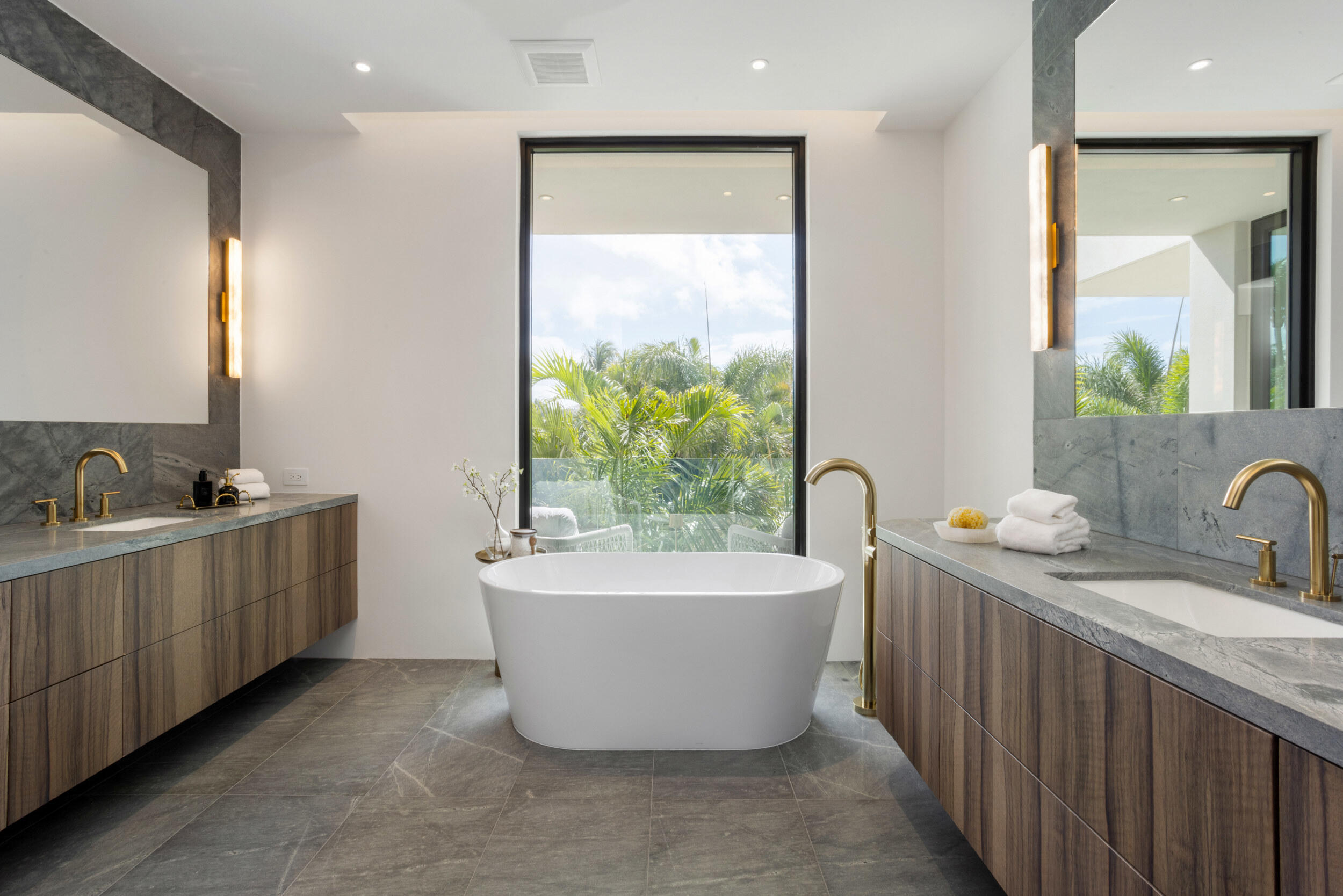 1252 George Bush Boulevard Delray Beach, FL 33483 - Photo 33 of 63 a bathroom with a bathtub sink and mirror