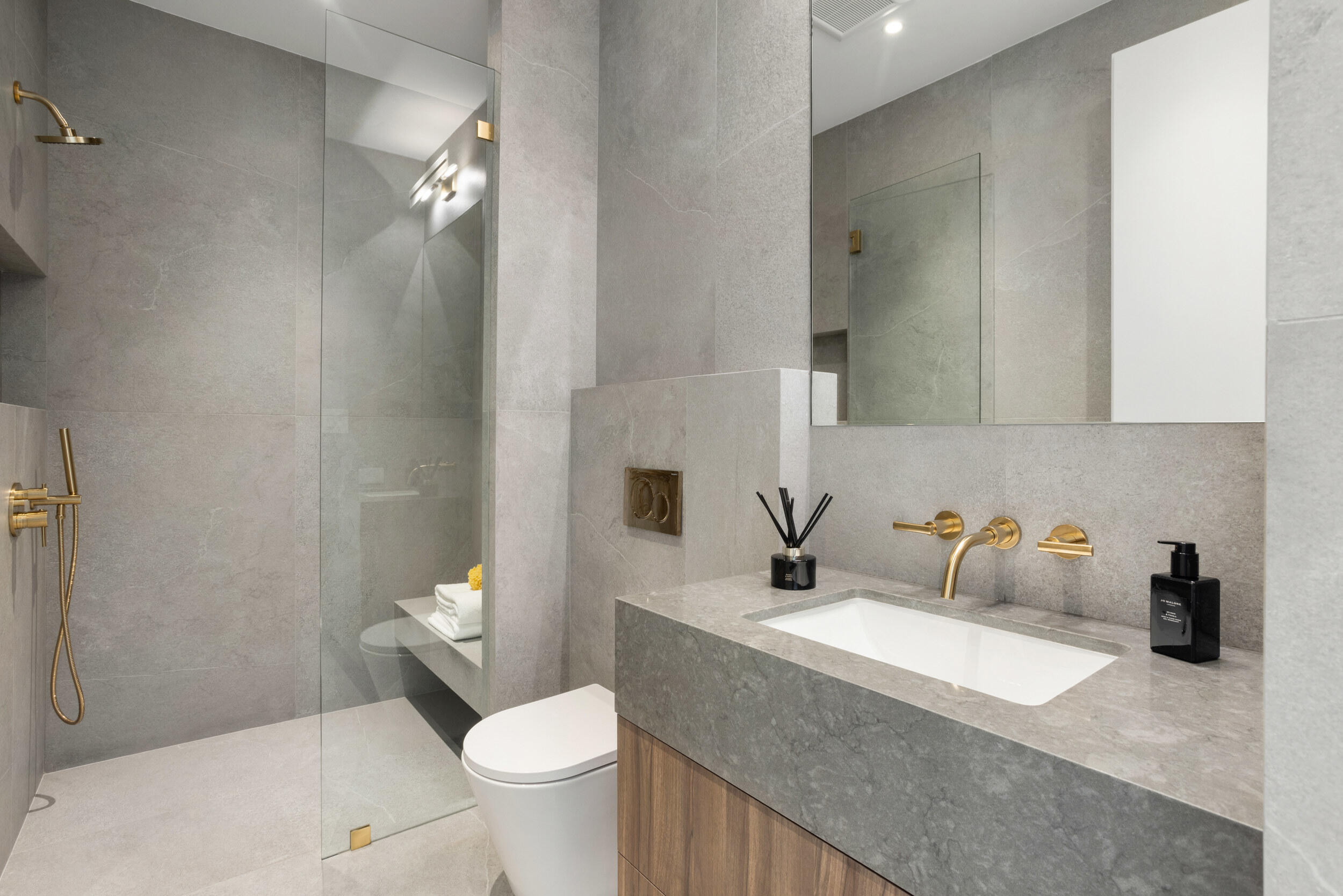 1252 George Bush Boulevard Delray Beach, FL 33483 - Photo 39 of 63 a bathroom with a granite countertop sink a toilet and a mirror