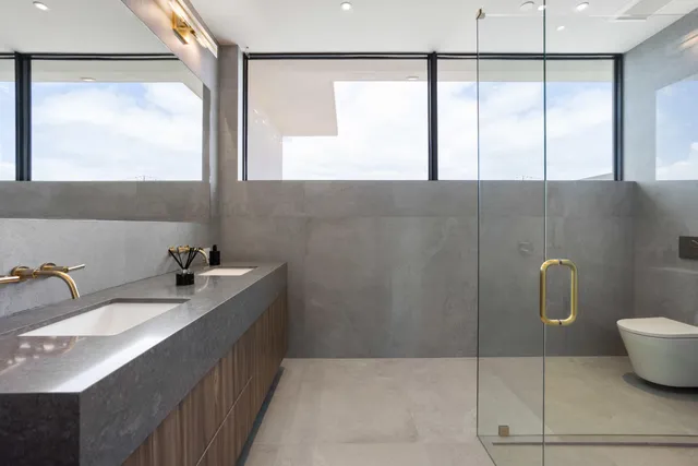 a living room with furniture a large window and dining table