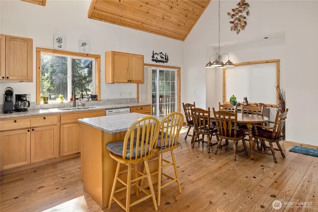 a large kitchen with stainless steel appliances granite countertop a stove and a refrigerator