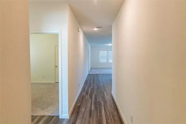 a view of hallway with wooden floor