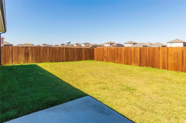 an empty room with a window and a fireplace