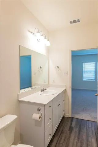 a bathroom with a toilet a sink and bathtub