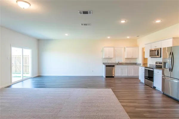 a view of house with backyard and trees