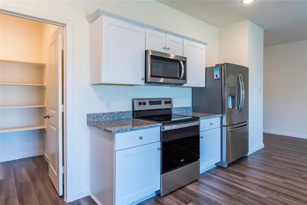 a dining room with furniture a kitchen island a sink and a refrigerator