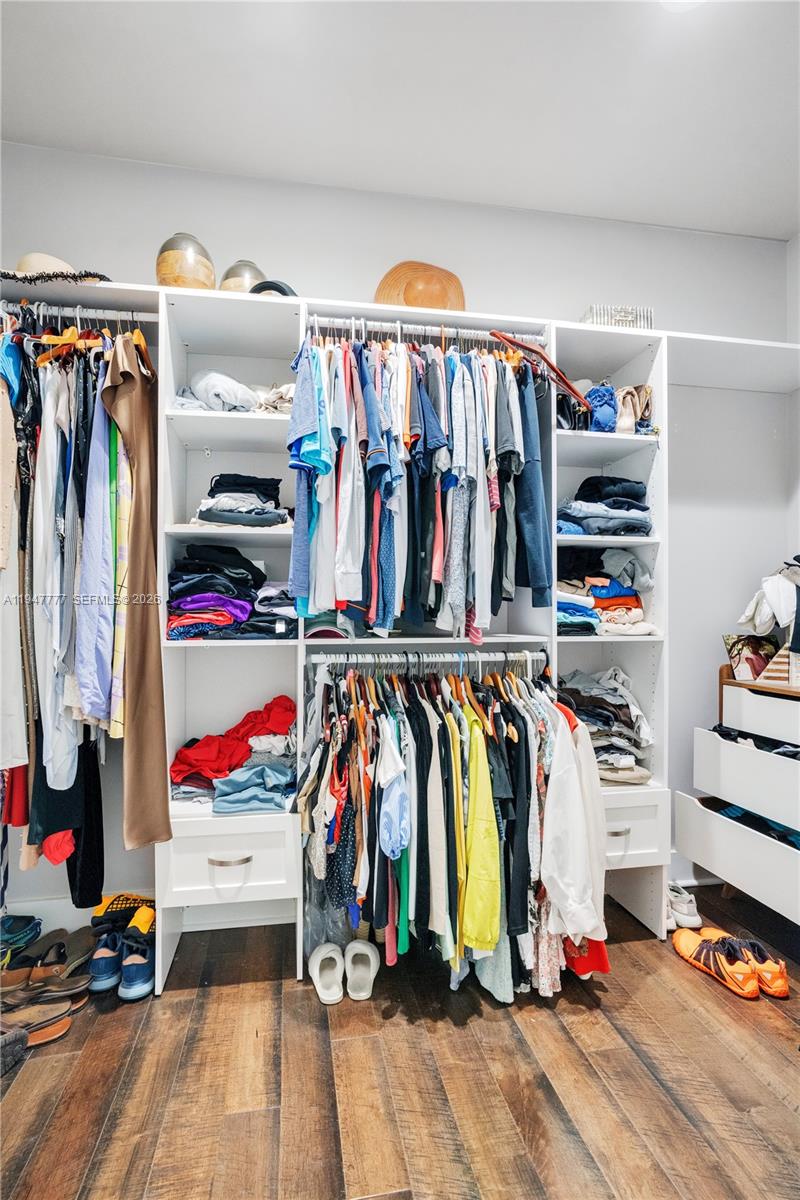 555 Peachtree Road Orlando, FL 32804 - Photo 11 of 35 a view of walk in closet with clothes and shoes