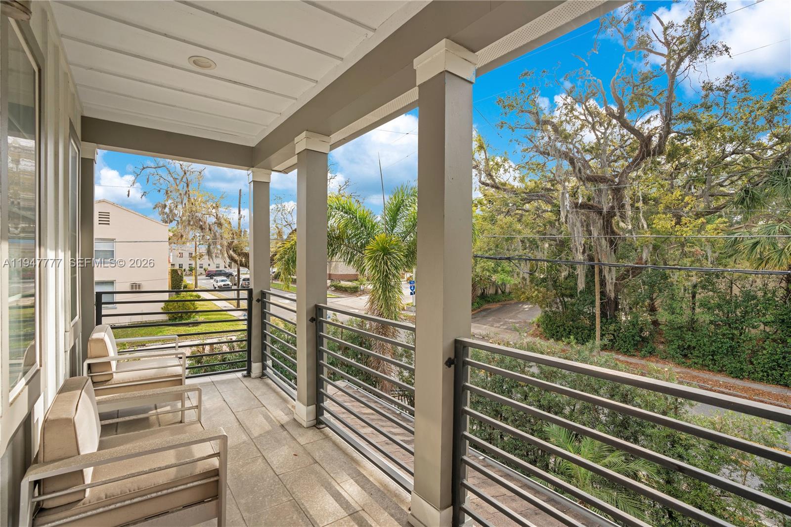 555 Peachtree Road Orlando, FL 32804 - Photo 21 of 35 a view of a balcony with floor to ceiling windows with wooden floor