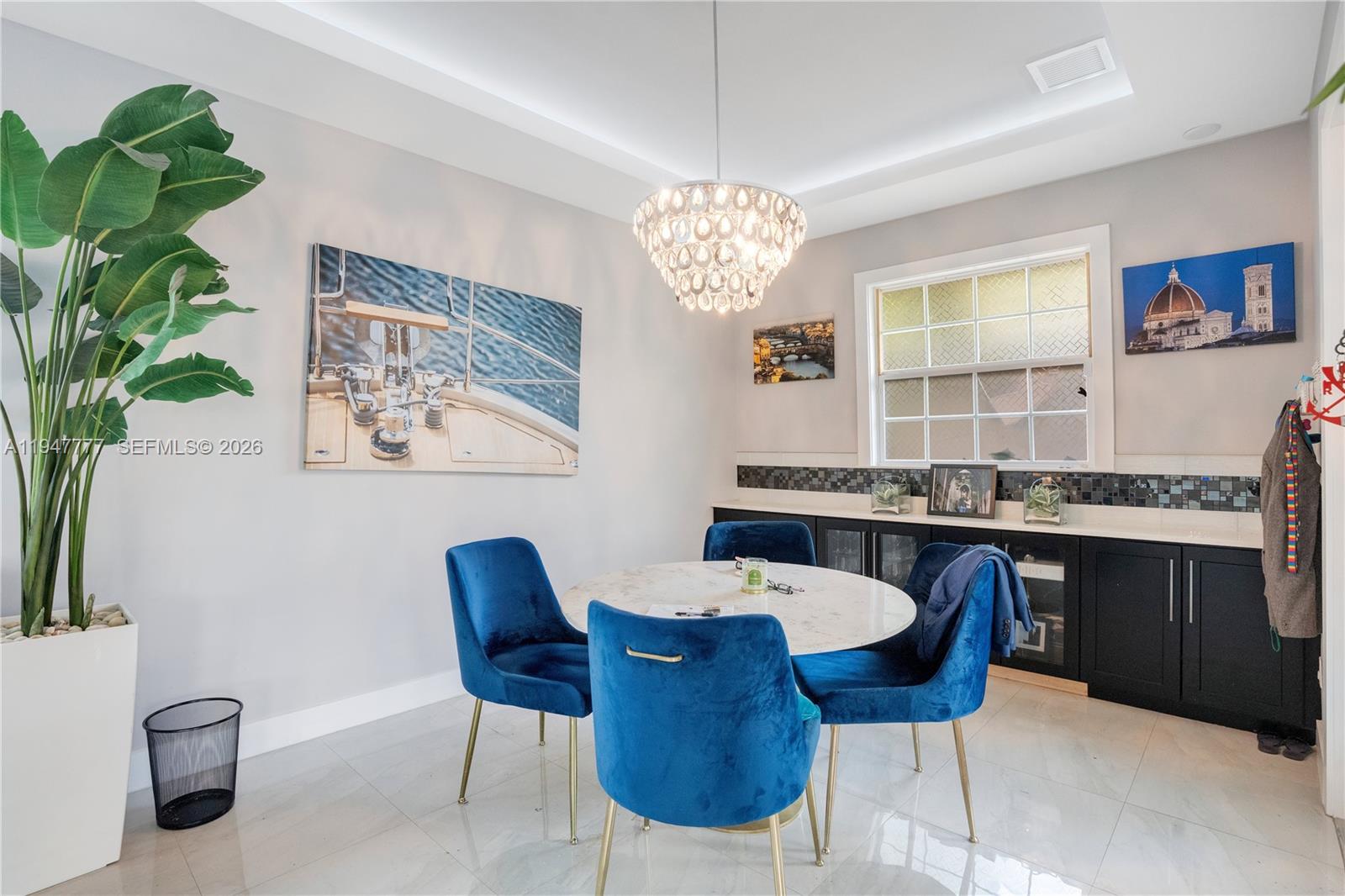 555 Peachtree Road Orlando, FL 32804 - Photo 9 of 35 a view of a dining room with furniture a chandelier and wooden floor