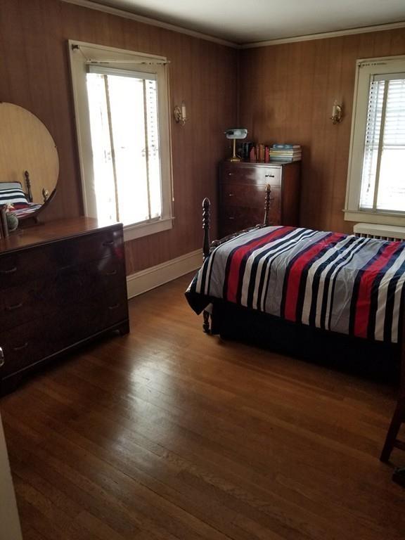 51 Reed Street Agawam, MA 01001 - Photo 11 of 14 a bedroom with a bed and wooden floor