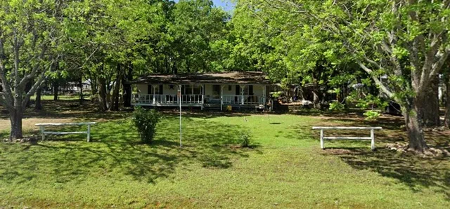 a view of house with backyard