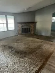 a view of empty room with a fireplace