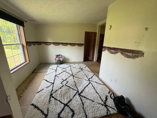a view of a hallway with wooden floor and a sink