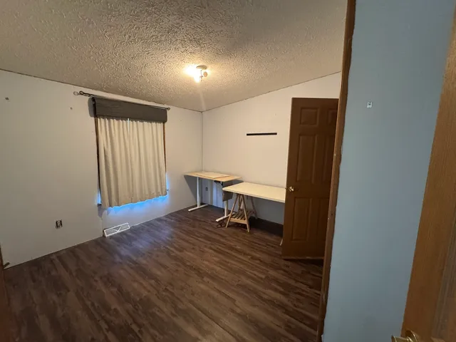 a view of hallway with wooden floor