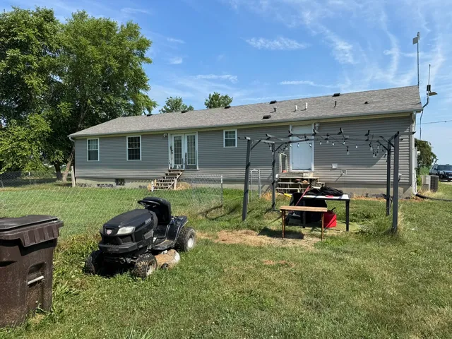a backyard of a house with yard and outdoor seating