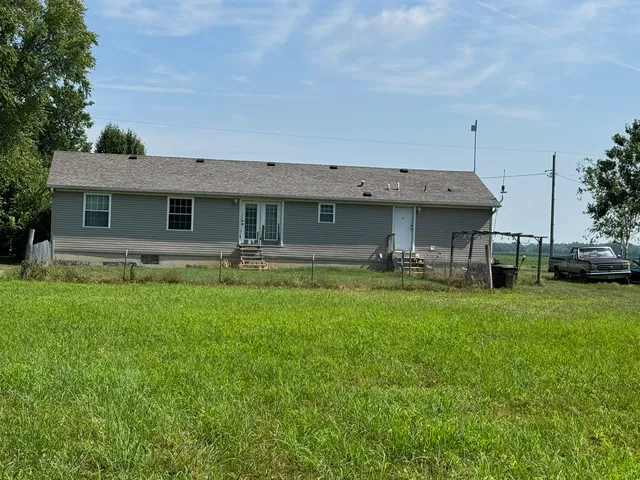 a front view of house with yard and outdoor seating
