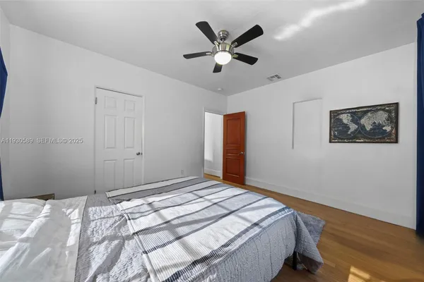 a bedroom with bed and a window