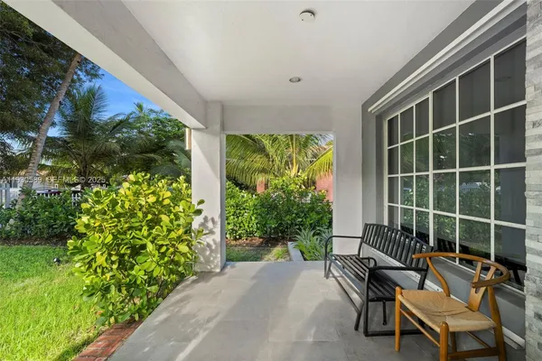 a view of a chairs and table in a backyard