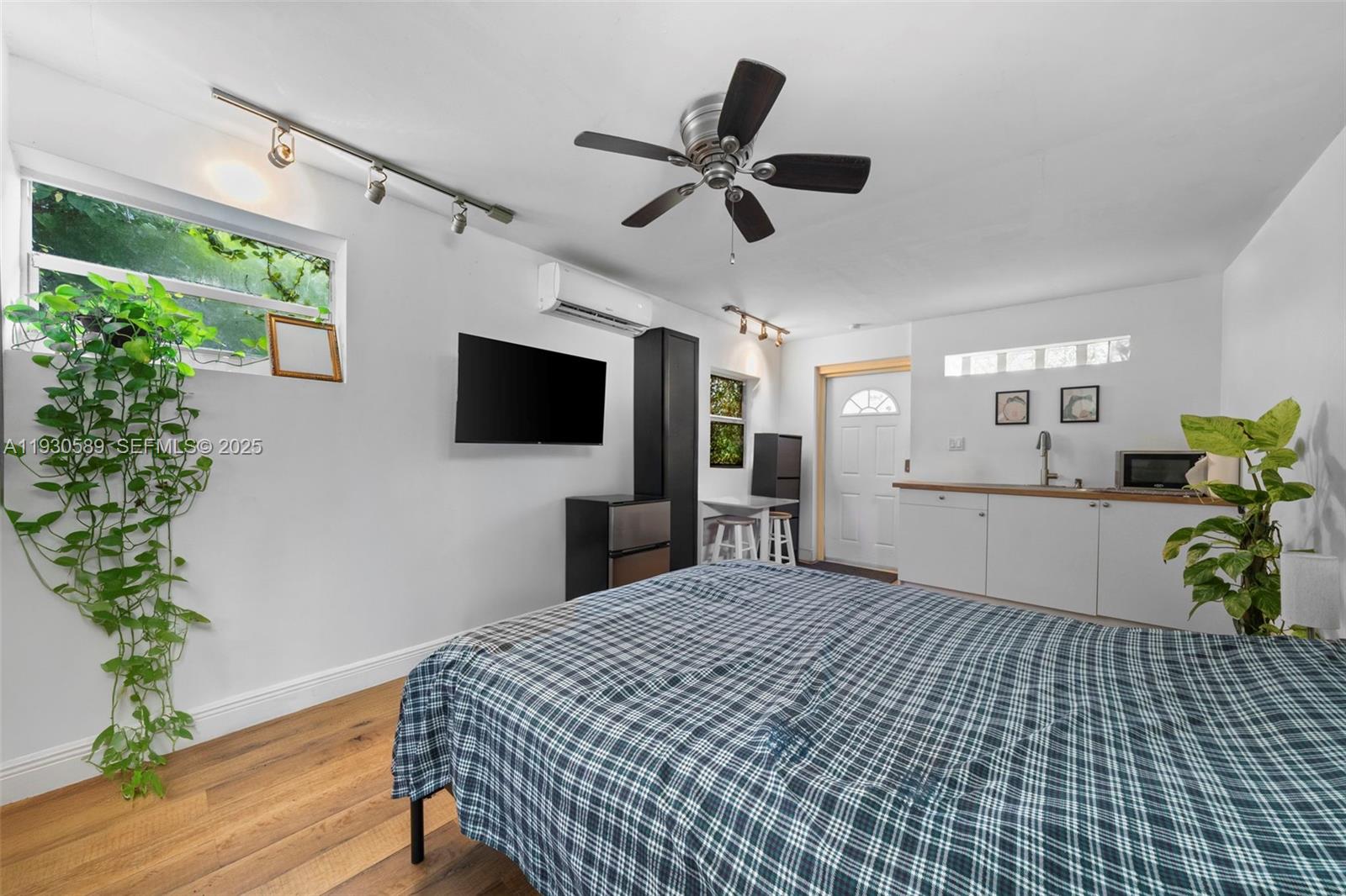 555 Northeast 73rd Street Miami, FL 33138 - Photo 29 of 32 a bedroom with a bed and a flat screen tv