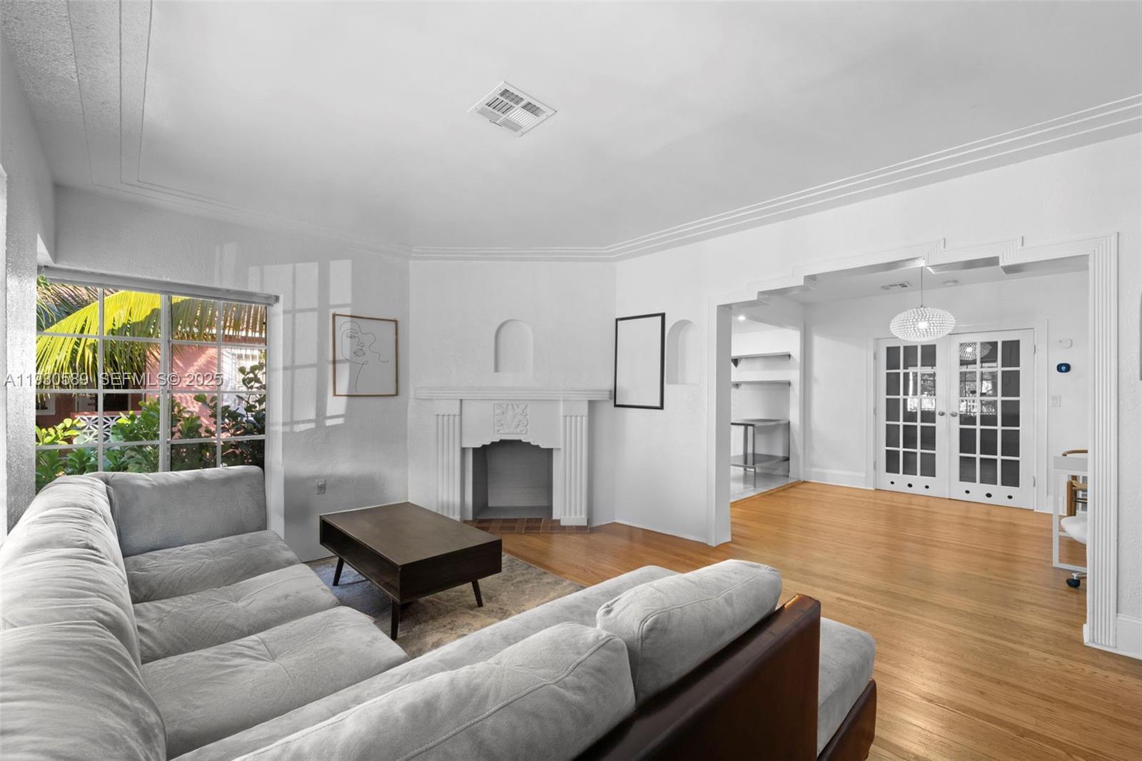 555 Northeast 73rd Street Miami, FL 33138 - Photo 3 of 32 a living room with furniture fireplace and a table