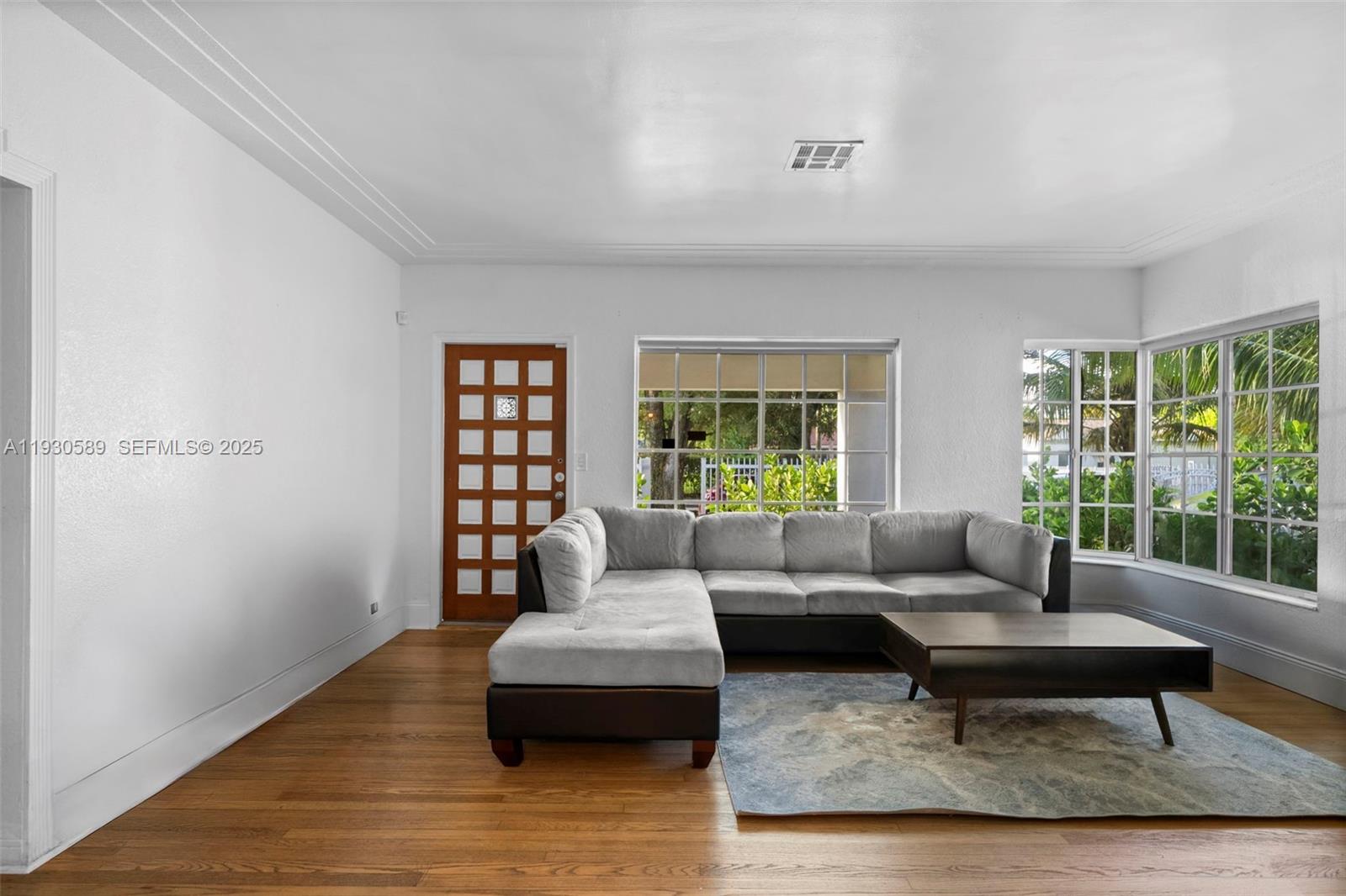 555 Northeast 73rd Street Miami, FL 33138 - Photo 4 of 32 a living room with furniture and a window