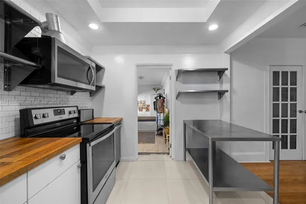 a kitchen with a stove and a refrigerator