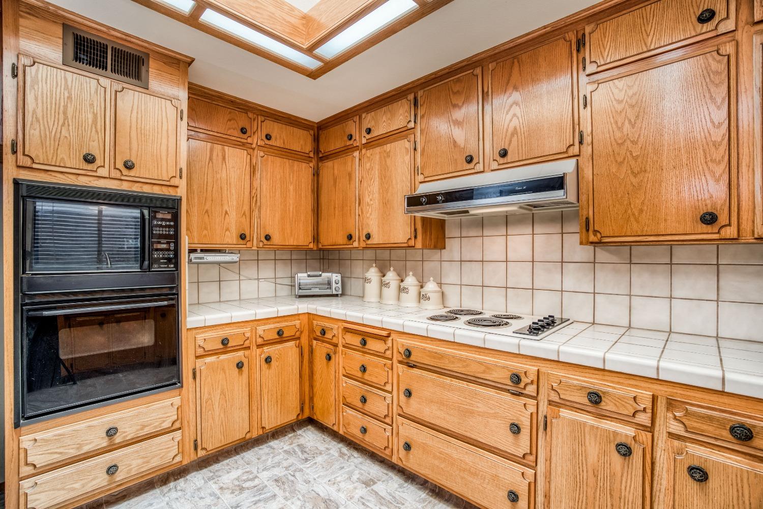 77 Post Avenue Sanger, CA 93657 - Photo 11 of 62 a kitchen with granite countertop cabinets stainless steel appliances and a sink