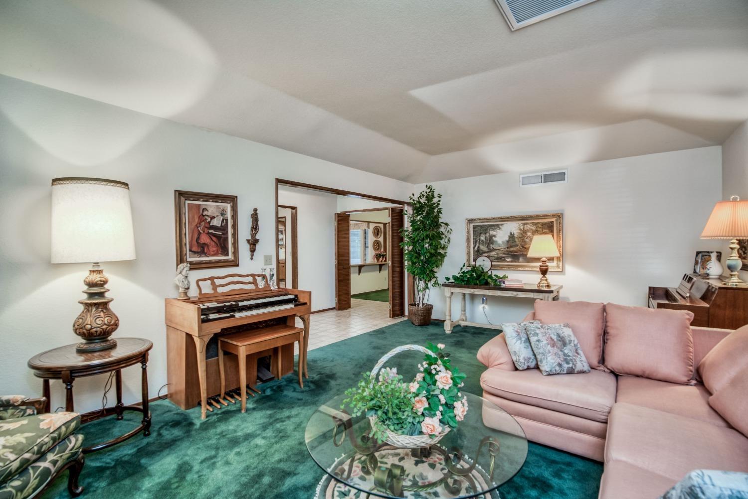 77 Post Avenue Sanger, CA 93657 - Photo 16 of 62 a living room with furniture a window and a lamp