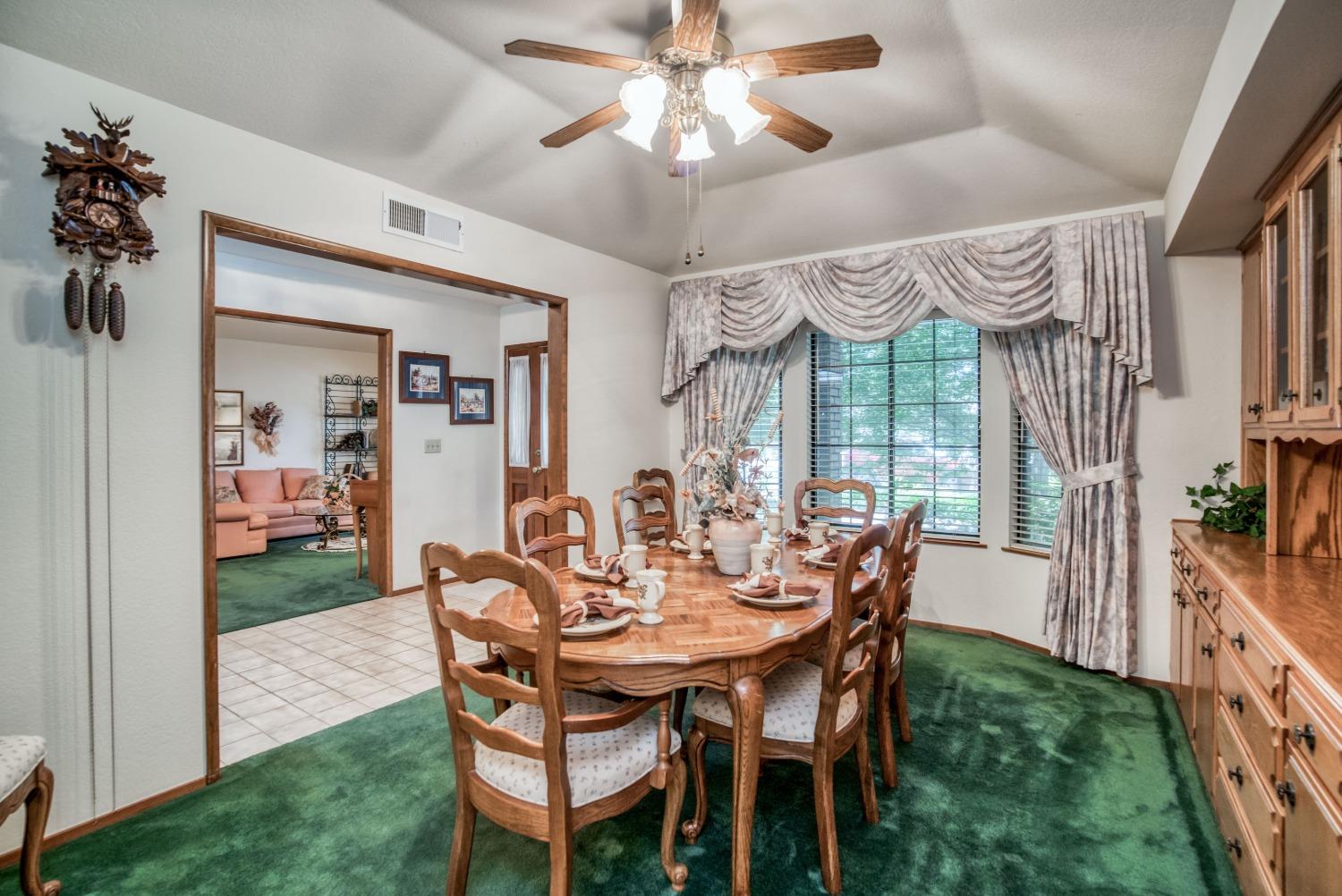 77 Post Avenue Sanger, CA 93657 - Photo 19 of 62 a view of a dining room with furniture window and wooden floor