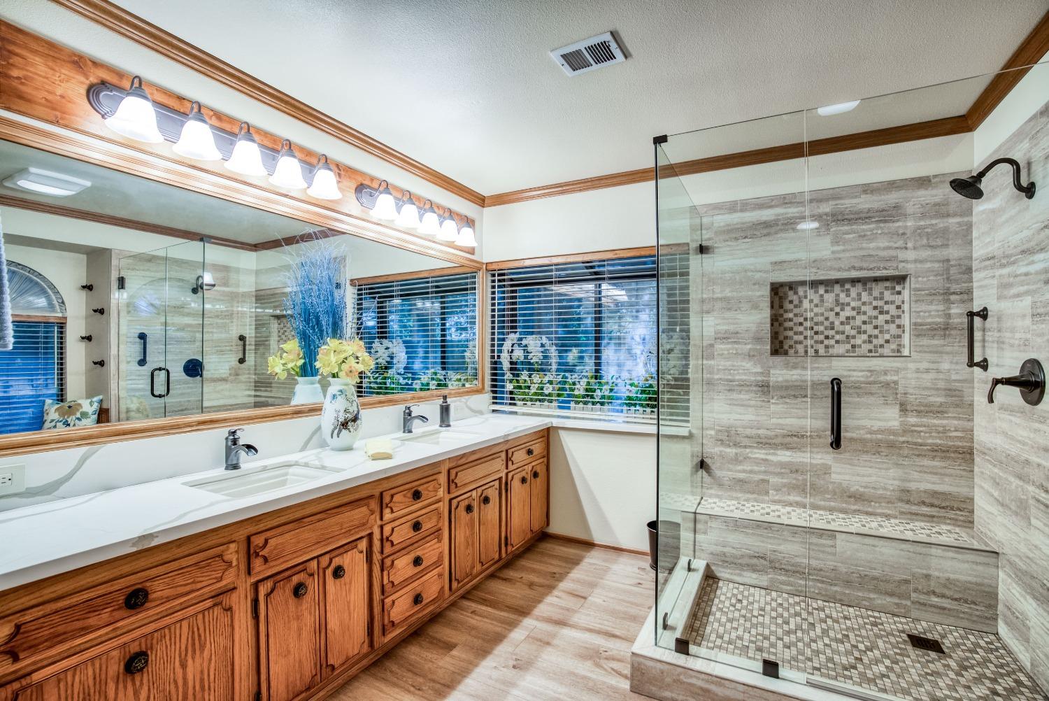 77 Post Avenue Sanger, CA 93657 - Photo 2 of 62 a bathroom with a sink a mirror and next to a window