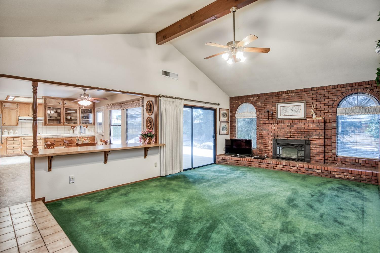 77 Post Avenue Sanger, CA 93657 - Photo 26 of 62 a view of a livingroom with furniture fire place and windows