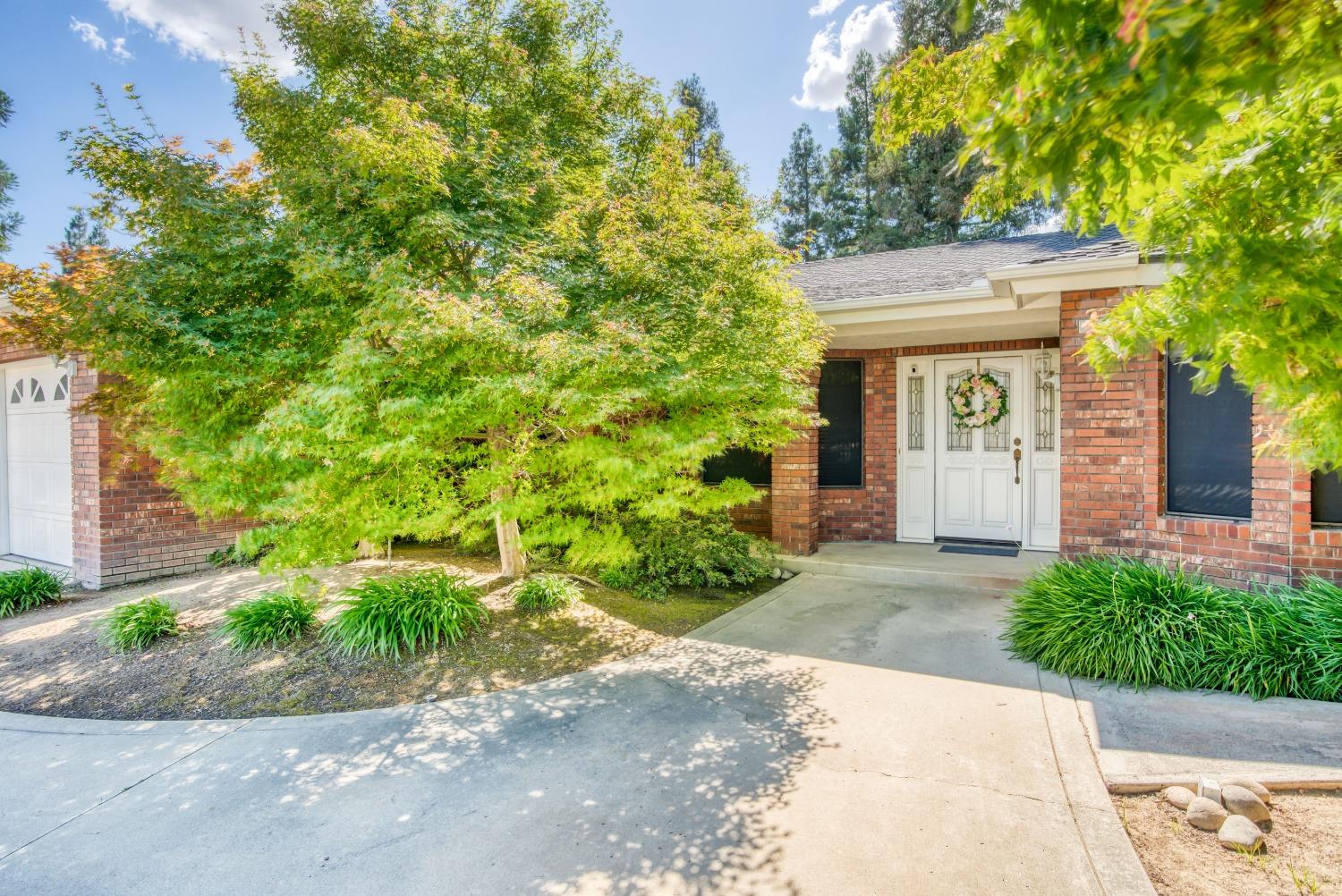 77 Post Avenue Sanger, CA 93657 - Photo 29 of 62 a front view of a house with a garden