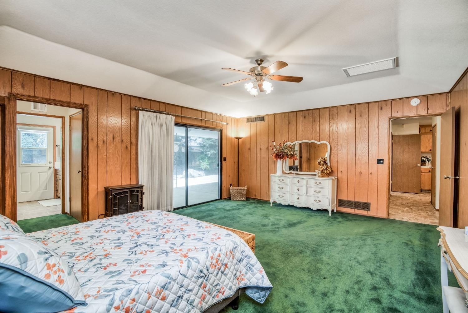 77 Post Avenue Sanger, CA 93657 - Photo 39 of 62 a spacious bedroom with a balcony a bed and a chandelier