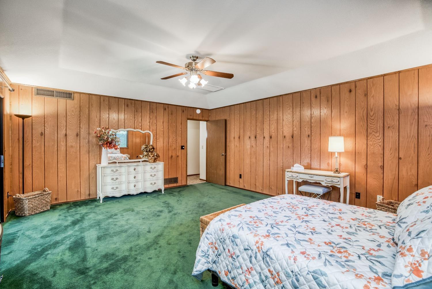 77 Post Avenue Sanger, CA 93657 - Photo 40 of 62 a bedroom with a large bed and a chandelier