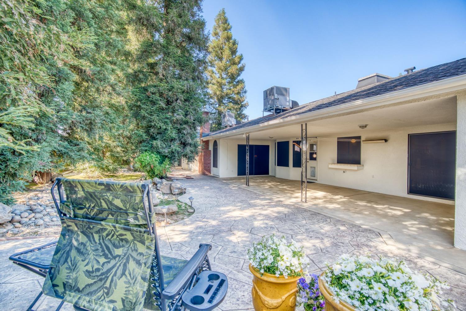77 Post Avenue Sanger, CA 93657 - Photo 4 of 62 a view of a house with backyard and sitting area