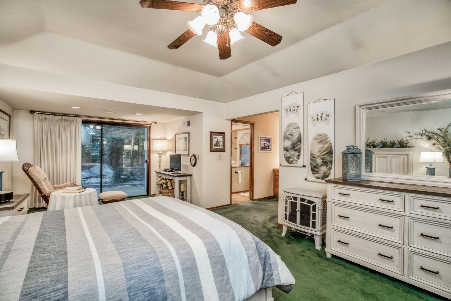 77 Post Avenue Sanger, CA 93657 - Photo 43 of 62 a bedroom with a large bed and a chandelier