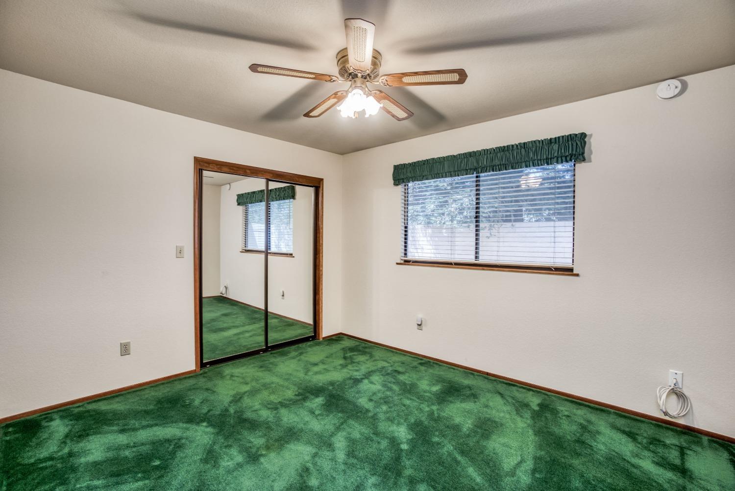 77 Post Avenue Sanger, CA 93657 - Photo 50 of 62 a view of an empty room with window and chandelier fan