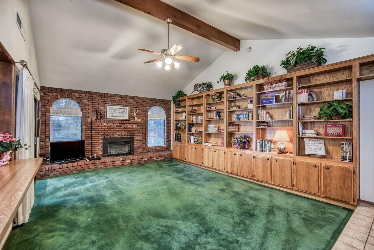 77 Post Avenue Sanger, CA 93657 - Photo 5 of 62 a view of an empty room with a fireplace and a window