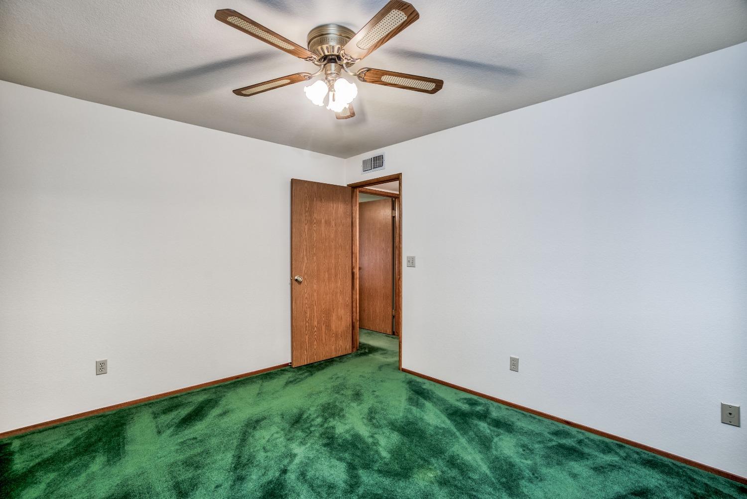 77 Post Avenue Sanger, CA 93657 - Photo 51 of 62 an empty room with a chandelier fan and closet