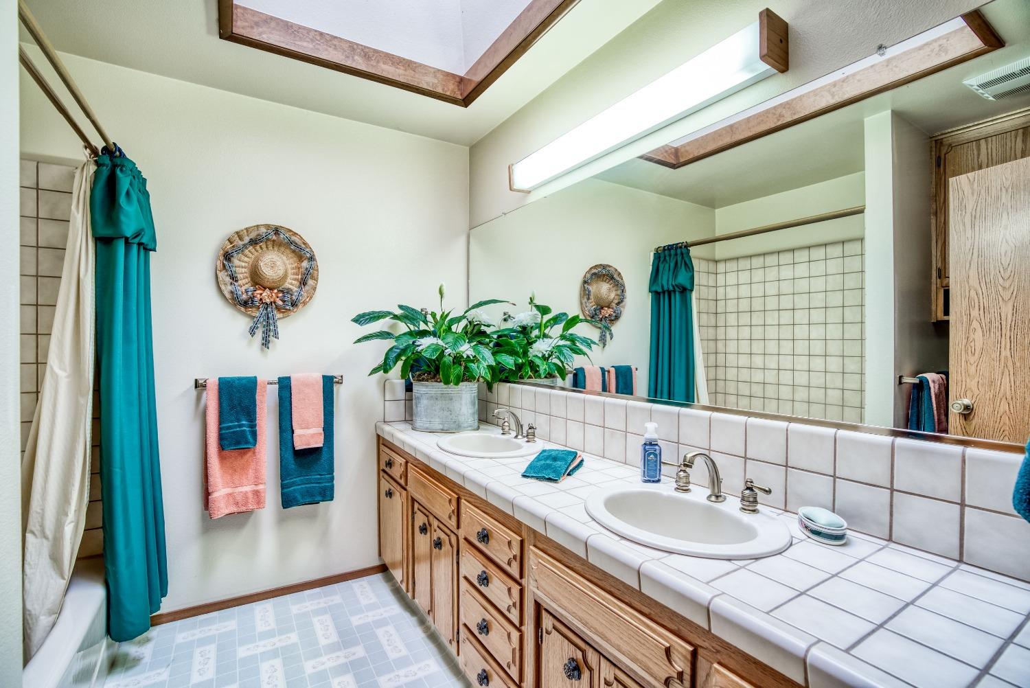 77 Post Avenue Sanger, CA 93657 - Photo 54 of 62 a bathroom with a double vanity sink and a mirror
