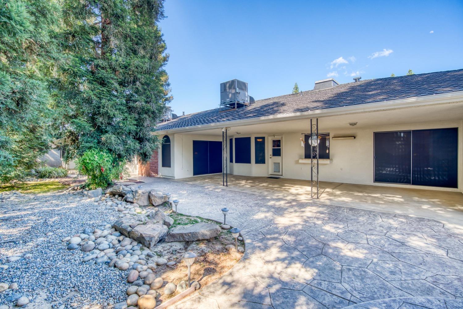 77 Post Avenue Sanger, CA 93657 - Photo 56 of 62 a front view of a house with a yard and garage
