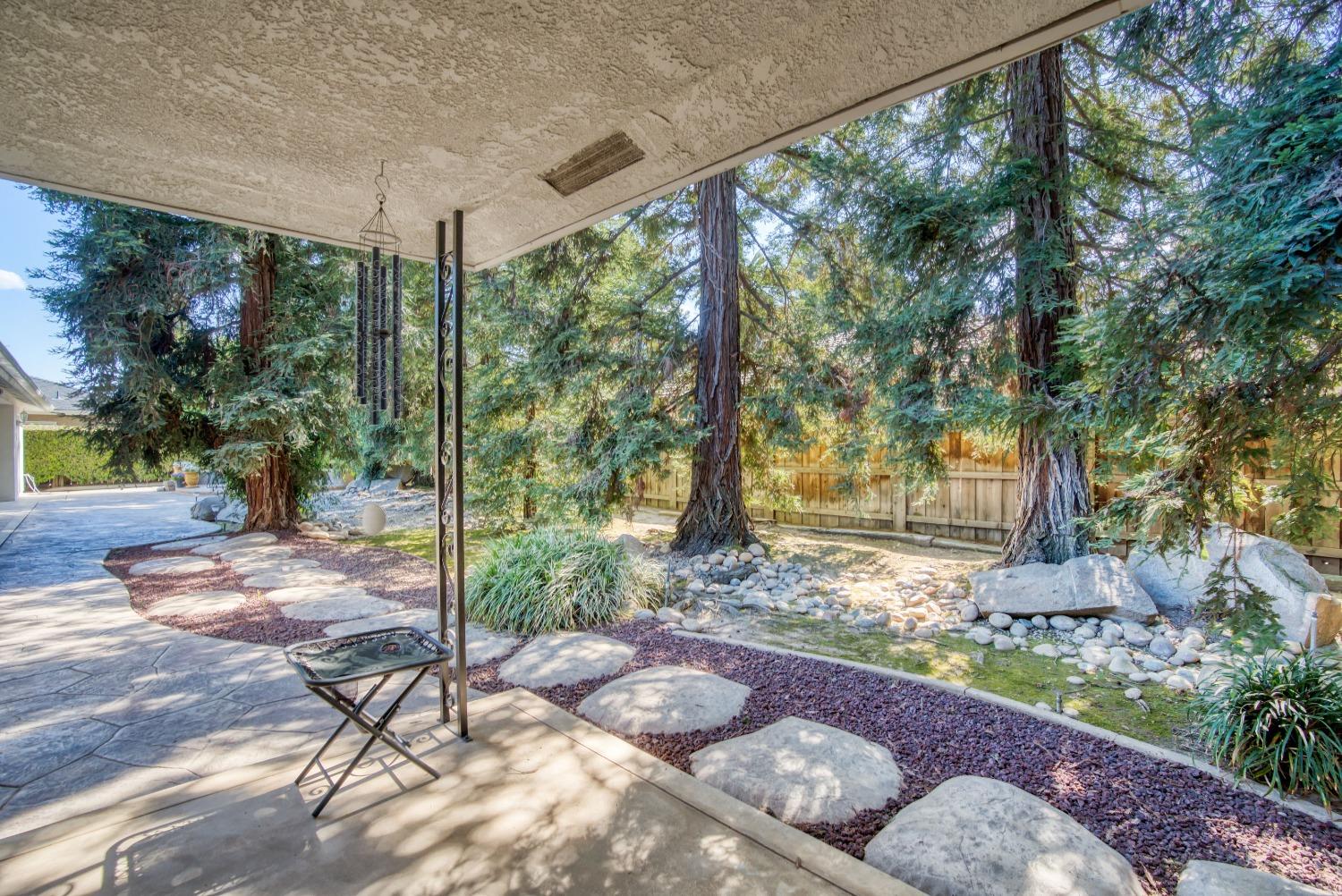 77 Post Avenue Sanger, CA 93657 - Photo 59 of 62 a view of a backyard with plants and garden