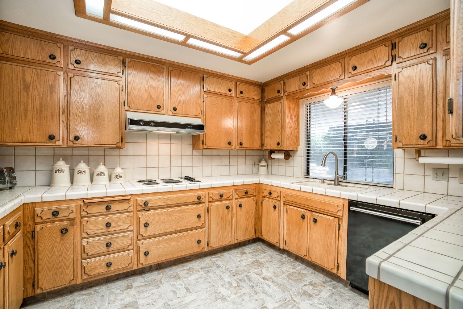 77 Post Avenue Sanger, CA 93657 - Photo 7 of 62 a kitchen with sink cabinets and window