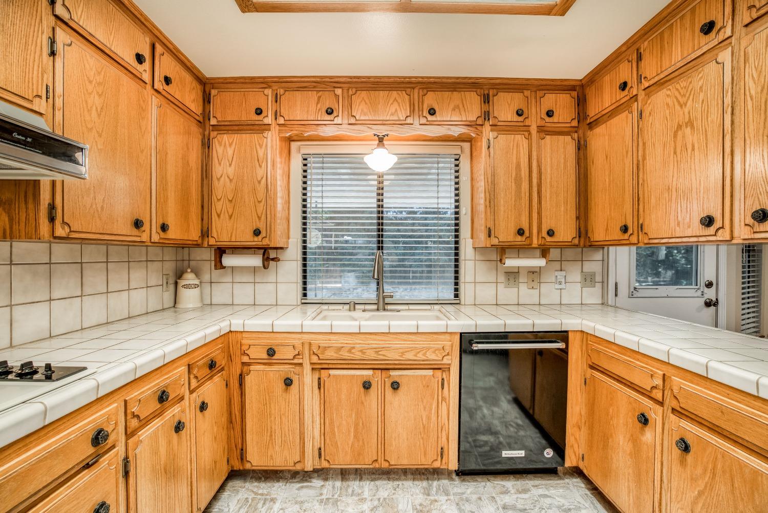 77 Post Avenue Sanger, CA 93657 - Photo 9 of 62 a kitchen with stainless steel appliances granite countertop a sink a stove and cabinets