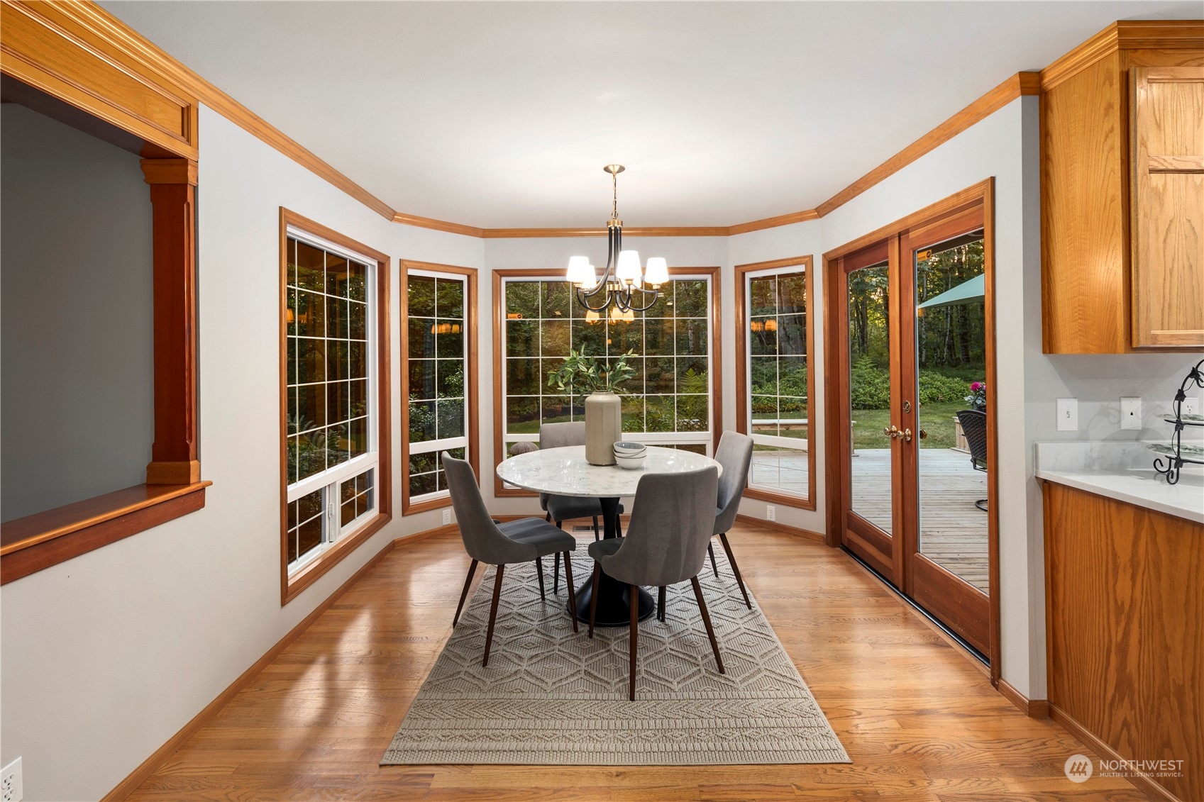 5381 242nd Place Northeast Redmond, WA 98053 - Photo 12 of 40 a dining room with furniture a chandelier and wooden floor