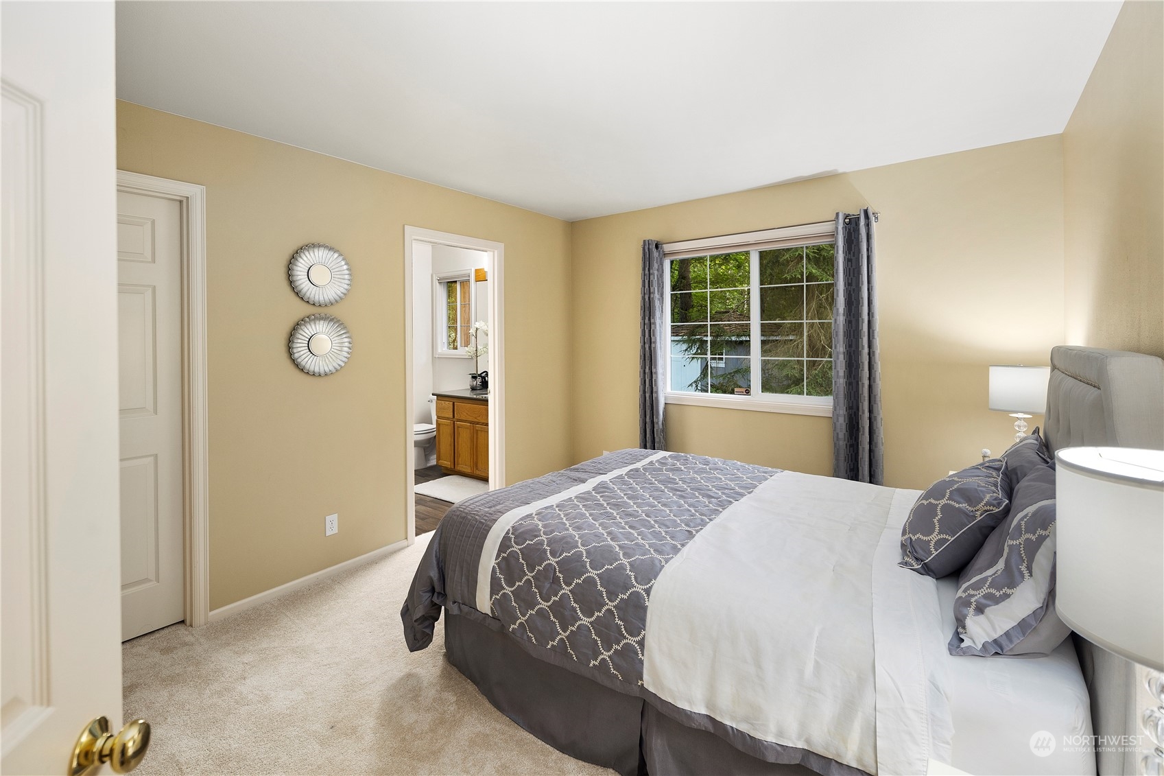 5381 242nd Place Northeast Redmond, WA 98053 - Photo 17 of 40 a bedroom with a bed and dresser with mirror