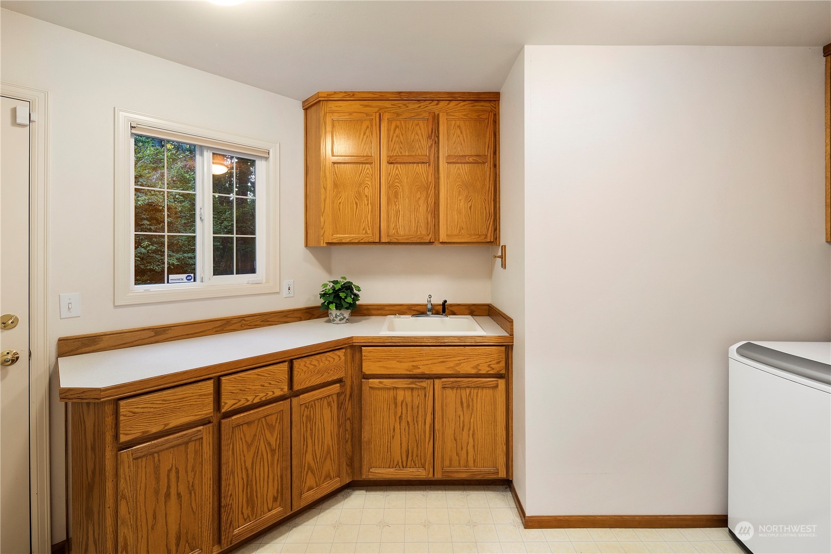 5381 242nd Place Northeast Redmond, WA 98053 - Photo 19 of 40 a utility room with a sink dryer and washer