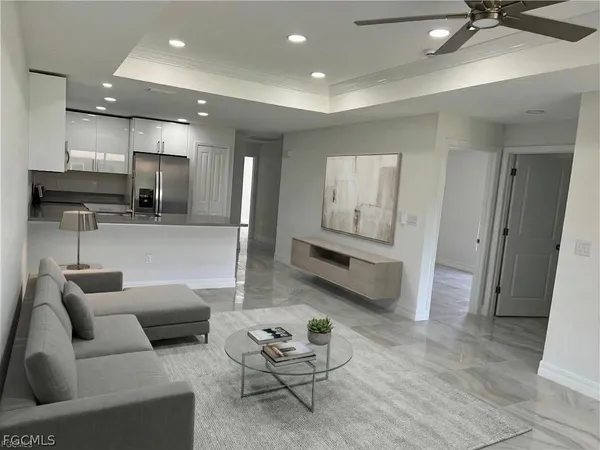 a living room with furniture and kitchen view